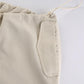 Light colored baggy parachute cargo pants with drawstring and low waist