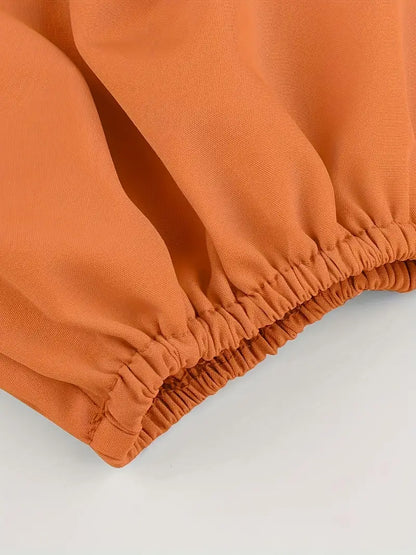 Blusa corta con hombros descubiertos y lazo en la espalda en color naranja 