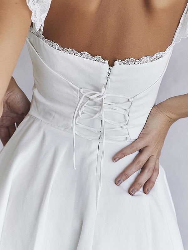 White mini dress with lace trim to tie at back