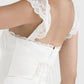 White mini dress with lace trim to tie at back